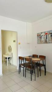 a dining room with a table and chairs at Elena Rooms-Apartments -B in Asprovalta
