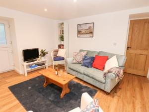 a living room with a couch and a coffee table at The Byre in Hexham