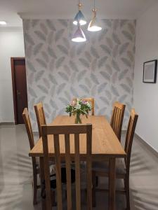 a dining room with a wooden table and chairs at Casa Feliz - Stylish 2 Bedroom Apartment in Addis Ababa