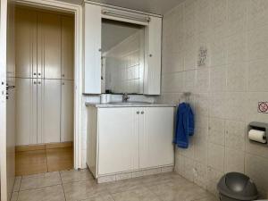 a kitchen with a sink and a mirror at Quiet place in Limassol