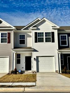 a large white house with two garage doors at Luray Caverns New Townhome with 3 bedrooms with 1500sqft in Luray