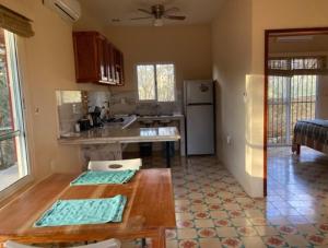 a kitchen with a table and a counter top at Casita Amarilla in the Yellow City in Izamal
