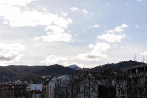 vistas a una ciudad con montañas y nubes en Magnifique F3 *Galaxy* tout équipé, en Clermont-Ferrand