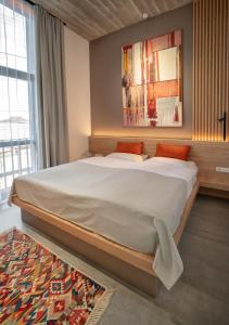 a bedroom with a large bed in a room at Erkan Alek Heritage Hotel in Gyumri