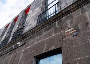a brick building with a sign on the side of it at Erkan Alek Heritage Hotel in Gyumri