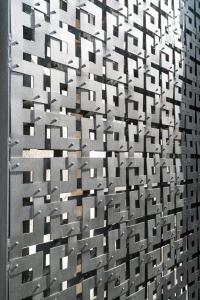 a metal wall with many squares on it at Erkan Alek Heritage Hotel in Gyumri