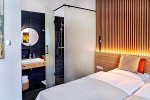 a bathroom with a bed and a shower and a sink at Erkan Alek Heritage Hotel in Gyumri
