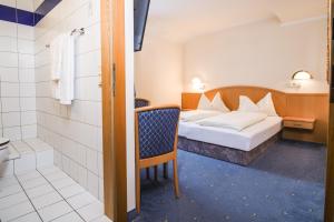 een hotelkamer met een bed en een badkamer bij Landhaus Gretl by S4Y in Krumpendorf am Wörthersee