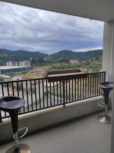 a balcony with two bar stools and a view at Depto in Temuco