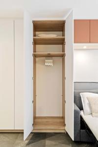 a closet in a bedroom with a bed at Classy Studio near to Cloche d'Or in Luxembourg