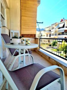 a balcony with a table and chairs on a balcony at olive house cozy studio in Nafplio