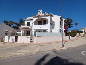 a white building on the side of a street at M&M Relax apartman in Torrevieja