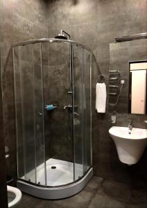 a bathroom with a glass shower and a sink at BLH in Yerevan