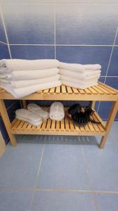 ein Regal mit Handtüchern und Hüten im Bad in der Unterkunft Apartmán l Praha centrum in Prag