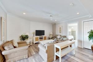 a living room with a couch and a tv at OC Condo 4100 #103 in Ocean City