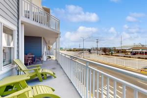 a balcony with two chairs and a table on a building at OC Condo 4100 #103 in Ocean City
