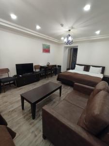 a living room with a bed and a couch at BLH in Yerevan