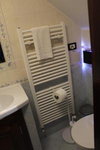a bathroom with a sink and a toilet and a towel at La Dimora di Ziella in Barisciano