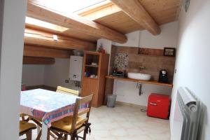 a kitchen with a table and a sink in a room at La Dimora di Ziella in Barisciano