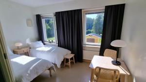 a hotel room with two beds and a window at EnjoyNature B&B in Lahti