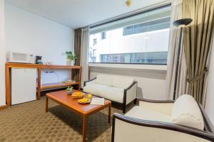 a living room with a couch and a table at Akros Galapagos Suite in Quito +29 photos