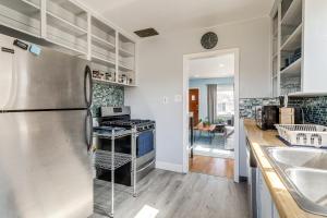 a kitchen with a stainless steel refrigerator and a sink at Inviting Aurora Vacation Rental about 7 Mi to Denver! in Aurora