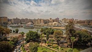 a view of a city with a river and a bridge at Zamalek X Hostel in Cairo