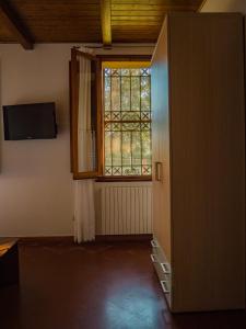 Habitación vacía con ventana y puerta en B&B Villa Erika, en Villa San Martino
