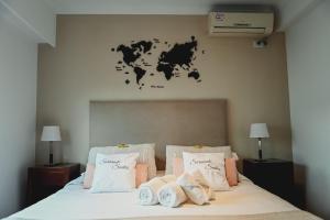 a bedroom with a bed with a world map on the wall at Sarmiento Suites Premium in Salta +33 photos