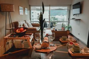 a living room with a table with wine bottles and glasses at Sarmiento Suites Premium in Salta