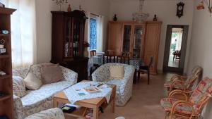 a living room with two couches and a table at Chez Leone in Grand Baie +2 photos