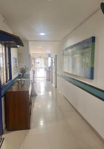a hallway of a building with a counter at Hotel Zandu in Pereira