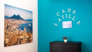 a room with a blue wall with a picture of a city at Casa Latilla in Naples