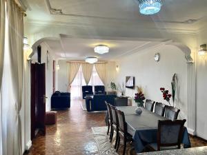 a dining room with a table and a living room at METRO Deluxe Specious Home in a Great Neighborhood!! in Addis Ababa