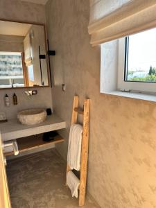 a bathroom with a towel rack and a sink at Casa Malìa Luxury Guest House in Luz