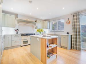 a kitchen with white cabinets and a sink at 4 Bed in Newlands Valley SZ204 in Braithwaite