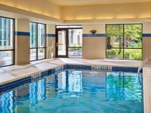 a swimming pool with blue water in a building at Parsippany Suites Hotel in Parsippany