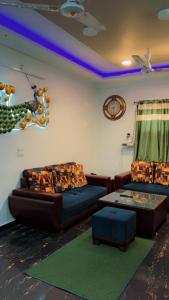 a living room with a couch and a table at The Harvard Home in Greater Noida