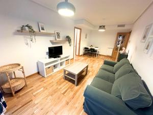 a living room with a couch and a table at Dos Torres César Augusto - Larga temporada in Zaragoza