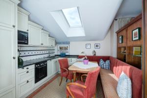 a kitchen with a table and some red chairs at Gasthof Schopper in Breitenbach am Inn