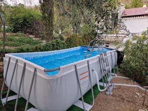 a large pool in a yard with a swing at Alora Sweet Home in Alora