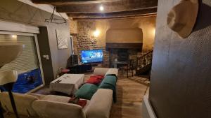 a living room with a couch and a fireplace at Hâvre de paix in Broons