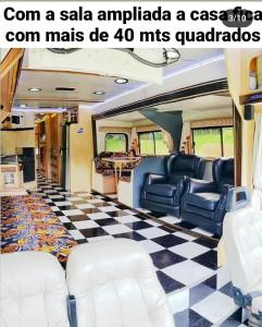 a train car with chairs and a checkered floor at Experiência num Luxuoso Motorhome in São Roque