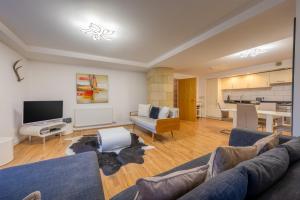 a living room with a couch and a dining room at AC19 Lower North Aisle - Luxury Self Catering 2 Bedroom Apartment in Fort Augustus