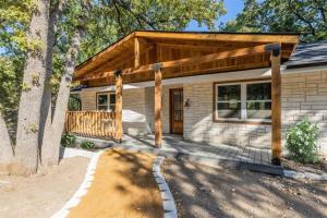 a log home with a porch and a deck at Cozy Texoma Hideaway with Tanglewood Resort Access in Pottsboro