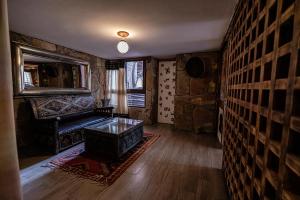 a living room with a couch and a table at Hotel Xaluca Dades in Boumalne