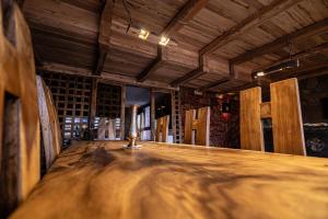 a room with a wooden table in a wine cellar at Hotel Xaluca Dades in Boumalne