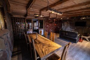 a large wooden table in a room with chairs at Hotel Xaluca Dades in Boumalne