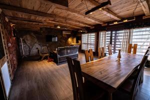 a dining room with a wooden table and chairs at Hotel Xaluca Dades in Boumalne