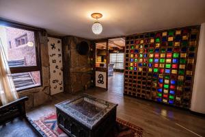 a room with a bunch of different colored bottles at Hotel Xaluca Dades in Boumalne